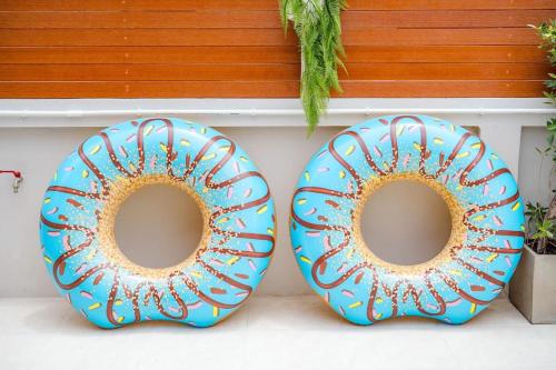 two blue donuts sitting next to a wall at come home pool villa cha-am in Phetchaburi