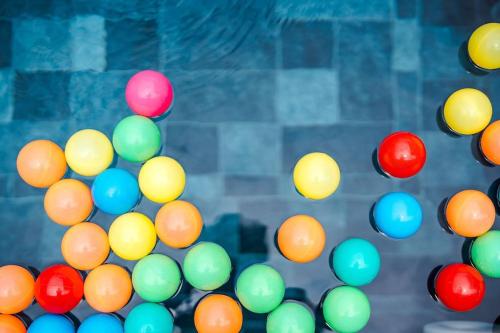 a bunch of colorful balls are on a wall at come home pool villa cha-am in Phetchaburi