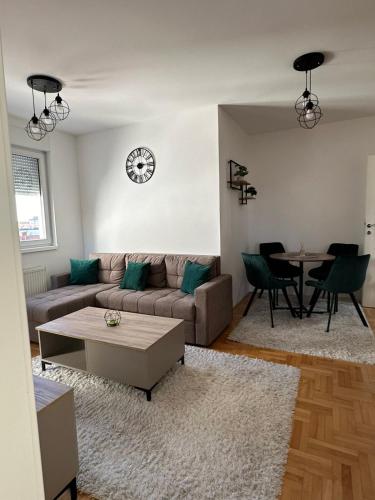a living room with a couch and a table at Kalman apartman in Bijeljina