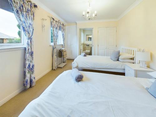 a bedroom with two beds and a window at Rokeby in Bamburgh