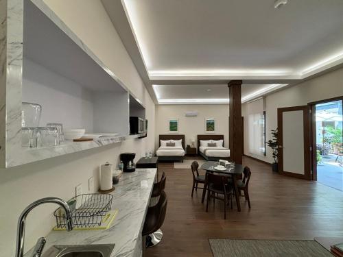 a kitchen and living room with a table and chairs at Casa Herrmann Suites in Mexico City