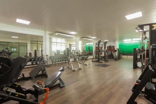a gym with several treadmills and cardio machines at Ritz Lagoa da Anta Hotel & SPA in Maceió