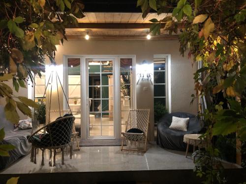 a patio with chairs and a couch on a porch at Domek w Pieninach Apartament Pałacowy Liliana in Krościenko