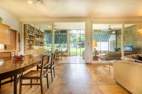 a kitchen and living room with a table and chairs at Family-Friendly Oasis with Pool in Cuernavaca in Cuernavaca
