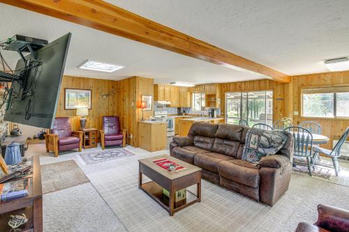 a living room with a couch and a table at Hiking, Hunting and Skiing Serene Sula Cabin in Sula