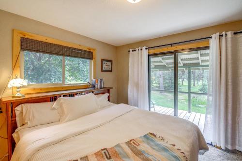 a bedroom with a bed and a large window at Hiking, Hunting and Skiing Serene Sula Cabin in Sula
