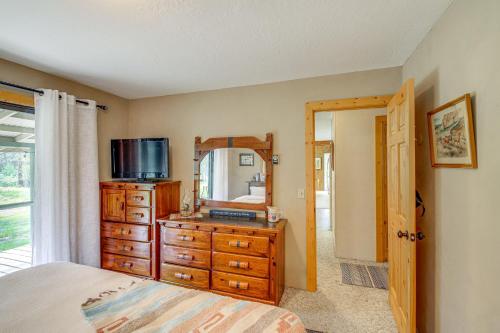 a bedroom with a dresser and a mirror at Hiking, Hunting and Skiing Serene Sula Cabin in Sula