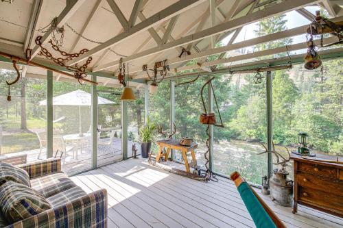 a screened in porch with a couch and a table at Hiking, Hunting and Skiing Serene Sula Cabin in Sula