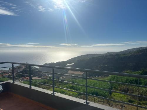 a view of the ocean from the balcony of a house at The View House in Ponta do Sol