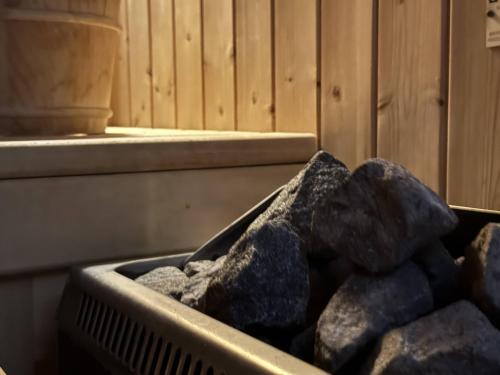 a bin full of rocks sitting next to a wall at HA Hotel in Bracciano