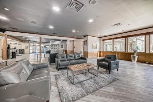 a large living room with couches and a table at Invermere Inn & Suites in Invermere