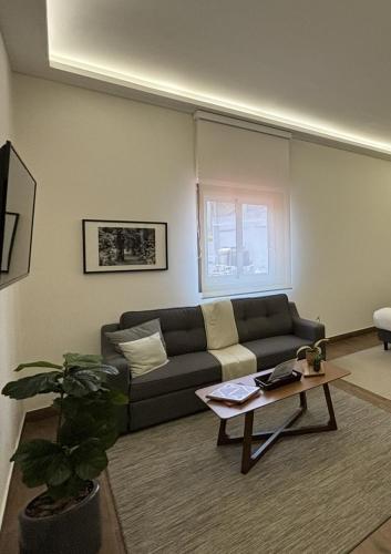 a living room with a couch and a table at Casa Herrmann Suites in Mexico City