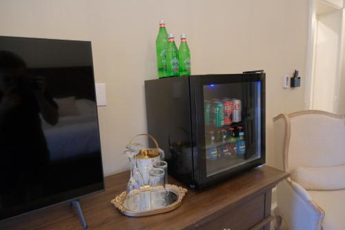 a tv sitting on a table next to a refrigerator at Mon Bijou in Oconomowoc