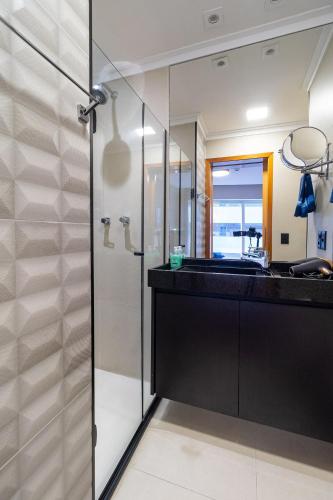 a bathroom with a glass shower and a sink at LFlats no Hotel Stella Vega (EX-Mercury Ibirapuera) in Sao Paulo