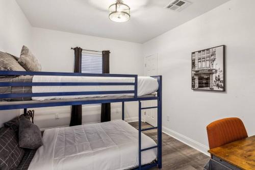 a bedroom with two bunk beds and a desk at Charming NOLA Oasis in New Orleans