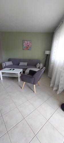 a living room with a couch and a table at Family House Dim in Ioannina