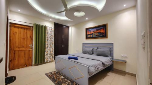 a bedroom with a bed and a ceiling at Castle INN in Dehradun