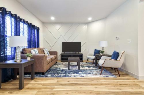 a living room with a couch and a tv at Timeless Beautiful Milwaukee Home Walking Distance to Downtown in Milwaukee