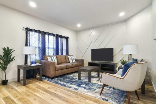 a living room with a couch and a tv at Timeless Beautiful Milwaukee Home Walking Distance to Downtown in Milwaukee