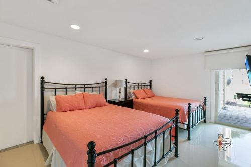 a bedroom with two beds and a window at Bahia Mar Solare Beachfront Resort Condos with Two Pools in South Padre Island