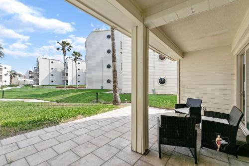 a patio with two chairs and a table at Bahia Mar Solare Beachfront Resort Condos with Two Pools in South Padre Island