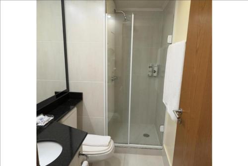 a bathroom with a shower with a toilet and a sink at Transamerica Executive Congonhas in Sao Paulo