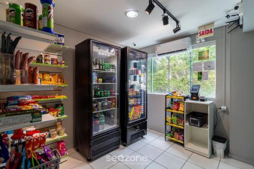 a kitchen with an open refrigerator with food inside at SPT - Studios Convenientes em Blumenau/SC in Blumenau