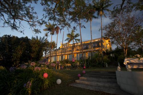 a building with palm trees in front of it at Villa Laurina in Saint-Paul