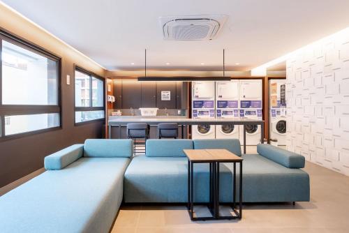 a living room with a couch and a table at GO Rio Branco by LikeHome in Porto Alegre