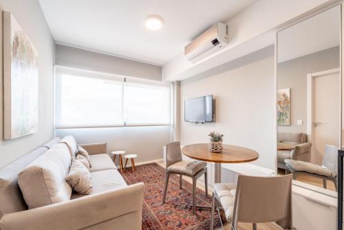 a living room with a couch and a table at GO Rio Branco by LikeHome in Porto Alegre