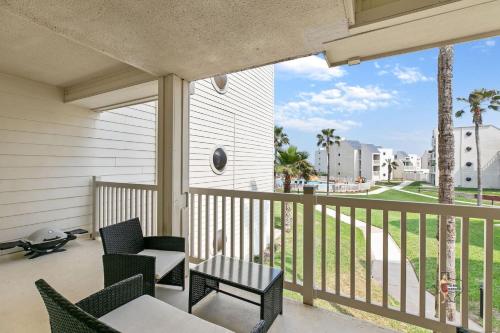 a balcony with chairs and tables and a view of a beach at Bahia Mar Solare Beachfront Resort Condos with Two Pools in South Padre Island