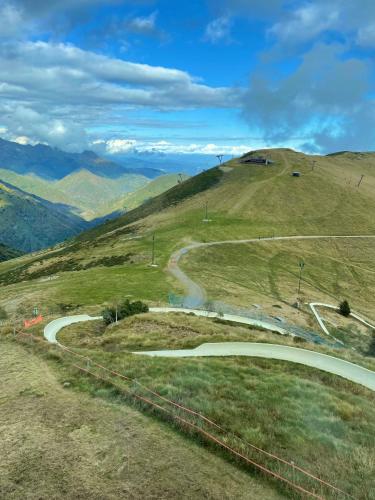 a winding road on a hill with mountains in the background at Studio ROSA in Miagliano