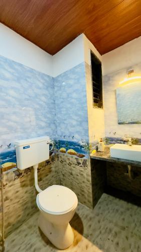 a bathroom with a toilet and a sink at Kashid Sunrise Resort in Kashid