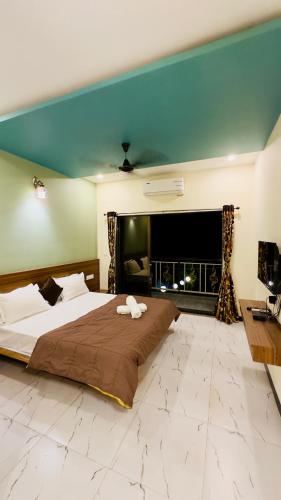 a large bedroom with a large bed and a fireplace at Kashid Sunrise Resort in Kashid