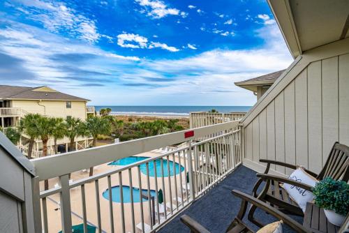 a balcony with chairs and a view of the beach at 319 Breakers in Hilton Head Island