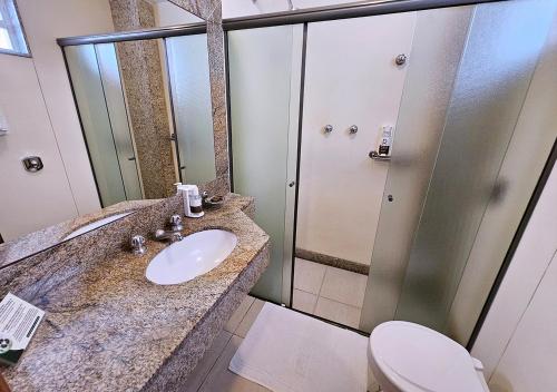a bathroom with a sink and a toilet and a shower at Riale Imperial Flamengo in Rio de Janeiro
