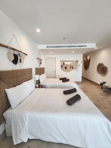 a bedroom with two beds with white sheets at Oceana by ABNA in Playa del Carmen
