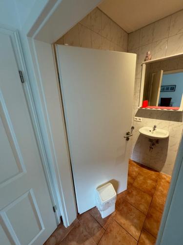 a small bathroom with a sink and a toilet at Zimmervermietung Heggemann in Lingen