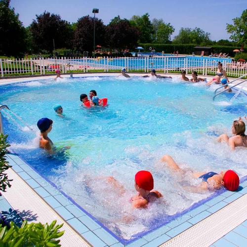 a group of children swimming in a swimming pool at Maryhouse in Borso del Grappa