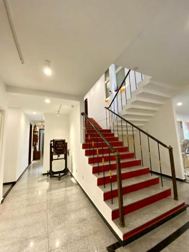 a staircase in a house with red and white stairs at Bayu Bayu Hotel by Soft Loft in Tanjung Bungah