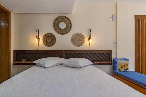a bedroom with a bed with two pillows on it at Quintal do Garnizé - Unidade Beija-Flor in Nova Petrópolis