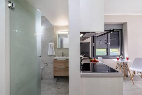 a kitchen with a sink and a counter top at Jasmine Apartments in Lefkada Town