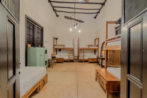 a large room with bunk beds and tables at Mamachá - Natural Residence in Valladolid