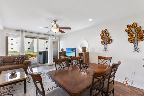 a living room with a table and a couch at Bahia Mar Solare Beachfront Resort Condos with Two Pools in South Padre Island