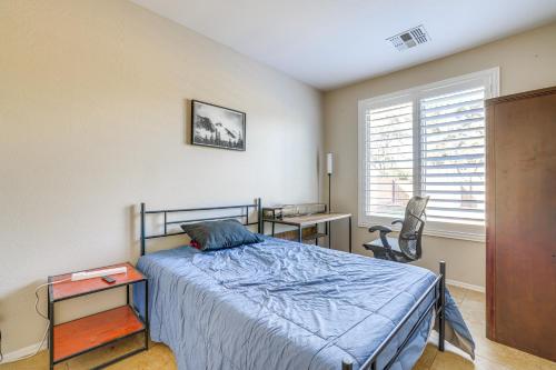 a bedroom with a bed and a desk and a window at Pool and Patio San Tan Valley Getaway! in Queen Creek