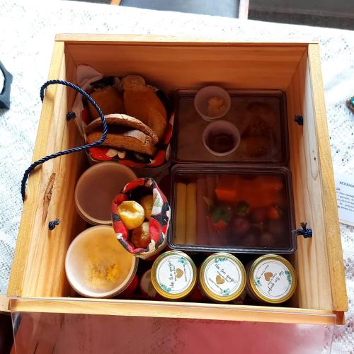 a wooden box filled with different types of food at Colline Verte in Monte Verde
