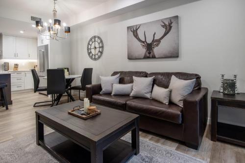 a living room with a couch and a table at Le Bucheron Stunning Spring Creek Luxury condo in Canmore