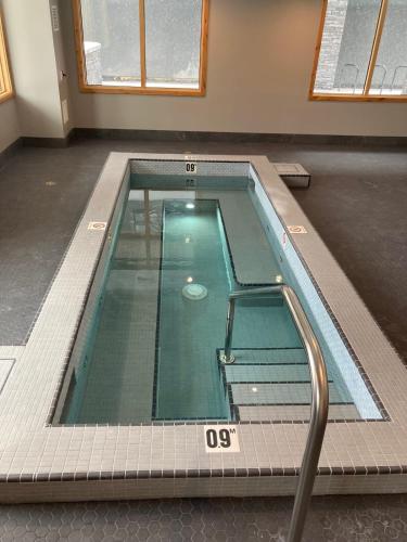 an empty swimming pool in a building with at Le Bucheron Stunning Spring Creek Luxury condo in Canmore