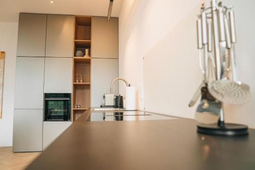 a kitchen with white cabinets and a counter top at RR - Penthouse - Luxe 105 qm - Central - WIFI in Magdeburg