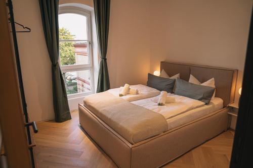 a bedroom with a large bed with a window at RR - Penthouse - Luxe 105 qm - Central - WIFI in Magdeburg